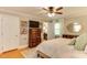 Relaxing bedroom featuring wood floors, ceiling fan, and access to the bathroom at 1206 Ivy Ln, Raleigh, NC 27609