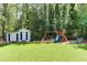 Backyard playground with a slide, swings and climbing ladder at 1206 Ivy Ln, Raleigh, NC 27609