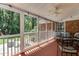 Enclosed sunroom with screen windows, a ceiling fan, and outdoor views at 1206 Ivy Ln, Raleigh, NC 27609