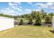 Grassy backyard with a view of mature trees, landscaping, and neighboring houses at 1230 Adrian Ct, Mebane, NC 27302