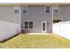 Spacious backyard with well-maintained grass, an AC unit, and a white privacy fence for added seclusion at 1230 Adrian Ct, Mebane, NC 27302