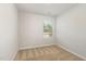 Neat bedroom showcasing neutral carpet, a window view, and light-colored walls creating a calm space at 1230 Adrian Ct, Mebane, NC 27302