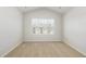 Empty bedroom with neutral carpet, white walls, and a view of other homes at 1230 Adrian Ct, Mebane, NC 27302