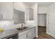 Updated kitchen with white subway tile backsplash, granite countertops, stainless faucet, and open layout at 1230 Adrian Ct, Mebane, NC 27302