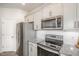 Well-equipped kitchen with granite countertops, stainless steel appliances, and white cabinets at 1230 Adrian Ct, Mebane, NC 27302