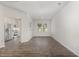 Open living room with hardwood floors leading to the kitchen with stainless steel appliances and natural light at 1230 Adrian Ct, Mebane, NC 27302