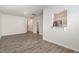 Open living room layout showcasing hardwood floors, a bar pass-through to the kitchen, and access to the upper levels at 1230 Adrian Ct, Mebane, NC 27302