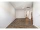 Empty living room with hardwood floors, access to upper levels, and a view into the bathroom at 1230 Adrian Ct, Mebane, NC 27302