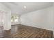 Empty living room with hardwood floors, and a large window providing abundant natural light at 1230 Adrian Ct, Mebane, NC 27302