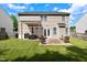 Expansive backyard with patio featuring a fire pit, pergola, and a manicured lawn for recreation and relaxation at 12417 Kendall Ridge Ct, Durham, NC 27703