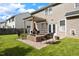 Backyard with brick patio area, seating under pergola, and a well-maintained lawn perfect for outdoor living at 12417 Kendall Ridge Ct, Durham, NC 27703