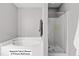 Separate tub and glass enclosed shower in the primary bathroom at 12417 Kendall Ridge Ct, Durham, NC 27703
