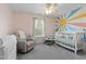 A Bedroom with a crib and glider offers the perfect space for your little one at 12417 Kendall Ridge Ct, Durham, NC 27703