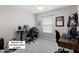 Second bedroom with a ceiling fan currently being used as an office at 12417 Kendall Ridge Ct, Durham, NC 27703