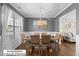 Elegant dining room with large window, wainscoting, and seating for six; ideal for Gathering dinners at 12417 Kendall Ridge Ct, Durham, NC 27703