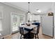 Bright eat-in kitchen features a breakfast bar, white cabinets, and views of the fenced backyard at 12417 Kendall Ridge Ct, Durham, NC 27703