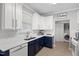 Stylish kitchen featuring two-tone cabinetry, quartz countertops, and modern stainless steel appliances at 12417 Kendall Ridge Ct, Durham, NC 27703