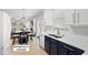 Open-concept kitchen with stainless steel appliances, blue and white cabinets, and a view of living space at 12417 Kendall Ridge Ct, Durham, NC 27703