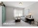 Comfortable living room featuring a neutral sofa, accent table, and stylish decor near a bright window at 12417 Kendall Ridge Ct, Durham, NC 27703