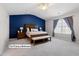 Spacious main bedroom features a large window with carpeted floors at 12417 Kendall Ridge Ct, Durham, NC 27703