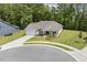 A beautiful single-story home with a manicured lawn on a cul-de-sac with mature trees at 1304 Essex Skipper Way, Fuquay Varina, NC 27526