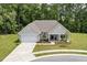 Aerial view of a charming single-Gathering home with a well-manicured front yard and attached two-car garage at 1304 Essex Skipper Way, Fuquay Varina, NC 27526