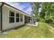 Backyard view of screened-in porch with patio furniture and lawn at 1304 Essex Skipper Way, Fuquay Varina, NC 27526