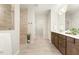 Bright bathroom features a double vanity, tiled shower, and walk in closet at 1304 Essex Skipper Way, Fuquay Varina, NC 27526