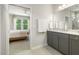 Modern bathroom featuring gray cabinetry, granite countertops, and a walk-in shower at 1304 Essex Skipper Way, Fuquay Varina, NC 27526