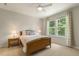 Bright bedroom with a ceiling fan and view of the forest at 1304 Essex Skipper Way, Fuquay Varina, NC 27526