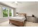 Bright bedroom featuring a large window, comfortable bed, and neutral decor at 1304 Essex Skipper Way, Fuquay Varina, NC 27526