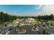 Community clubhouse featuring a pool, pickleball courts, ample parking, and lush landscaping at 1304 Essex Skipper Way, Fuquay Varina, NC 27526