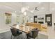 Open-concept dining area, adjacent to the living room with access to outdoor space at 1304 Essex Skipper Way, Fuquay Varina, NC 27526