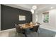 Dining room with modern light fixture, accent wall and wood table at 1304 Essex Skipper Way, Fuquay Varina, NC 27526