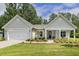 Charming single-story home featuring a pristine front yard and an attached garage with a lovely front porch at 1304 Essex Skipper Way, Fuquay Varina, NC 27526