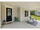 Cozy porch featuring a welcome mat, outdoor chairs, and a green view at 1304 Essex Skipper Way, Fuquay Varina, NC 27526