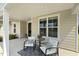 Inviting front porch featuring chairs, a table, and a stylish rug for relaxing and enjoying the outdoors at 1304 Essex Skipper Way, Fuquay Varina, NC 27526
