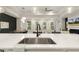 Open-concept kitchen featuring a stainless steel sink and quartz countertops at 1304 Essex Skipper Way, Fuquay Varina, NC 27526