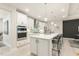 Bright, modern kitchen with a large island, quartz countertops, and stainless steel appliances at 1304 Essex Skipper Way, Fuquay Varina, NC 27526