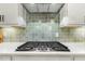 Close-up of the kitchen cooktop with a decorative backsplash at 1304 Essex Skipper Way, Fuquay Varina, NC 27526