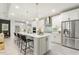 Spacious kitchen showcasing a large island with seating and stainless steel appliances at 1304 Essex Skipper Way, Fuquay Varina, NC 27526