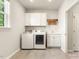 Well-lit laundry room equipped with modern washer, dryer, and sink at 1304 Essex Skipper Way, Fuquay Varina, NC 27526
