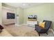 Relaxing living room with soft green walls, a flat-screen TV, and a comfortable sofa and chair at 1304 Essex Skipper Way, Fuquay Varina, NC 27526