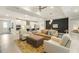 Open-concept living room with hardwood floors, comfortable seating, and access to the kitchen at 1304 Essex Skipper Way, Fuquay Varina, NC 27526