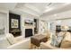 Bright open-concept living room with a fireplace, and views into the kitchen at 1304 Essex Skipper Way, Fuquay Varina, NC 27526