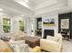 Bright living room with fireplace, mounted television, and tray ceilings at 1304 Essex Skipper Way, Fuquay Varina, NC 27526
