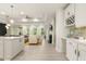Open-concept living area with white cabinets, a fireplace, and seamless flow to the living area at 1304 Essex Skipper Way, Fuquay Varina, NC 27526