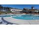Stunning pool area featuring a large pool, lounge chairs, and inviting umbrellas, perfect for relaxation and recreation at 1304 Essex Skipper Way, Fuquay Varina, NC 27526