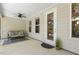 Screened porch features a cozy seating area with a view of the backyard and patio at 1304 Essex Skipper Way, Fuquay Varina, NC 27526