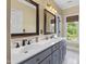 Elegant bathroom features a double sink vanity, custom mirror frames, and ample counter space for convenience at 1329 Wynncrest Ct, Raleigh, NC 27603